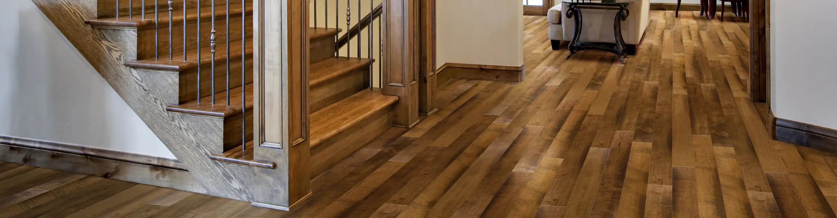 Oak hardwood flooring in a front foyer with staircase 